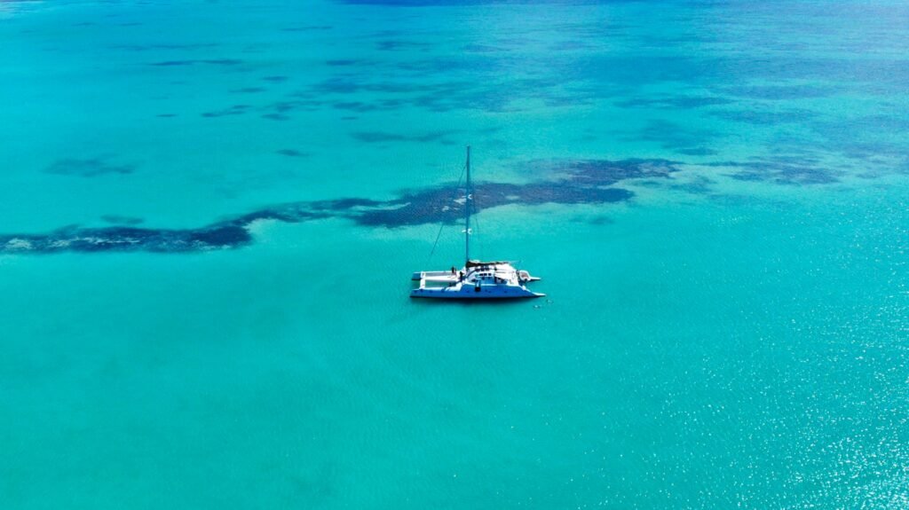 White catamaran on clear turquoise Caribbean water